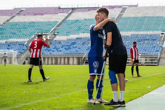Robin Söder embraces Emil Holm of IFK Göteborg, who is
