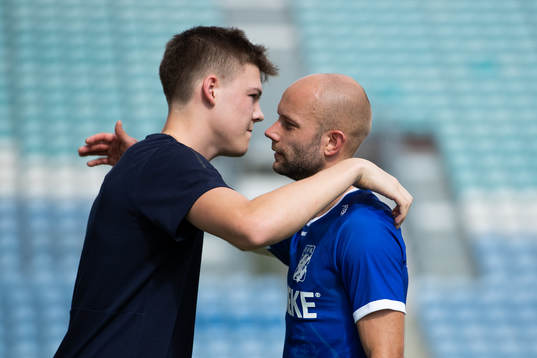 Emil Holm of IFK Göteborg gets a hug from team mate Robin