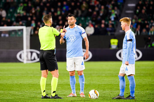Behrang Safari of Malmö FF receives a yellow card