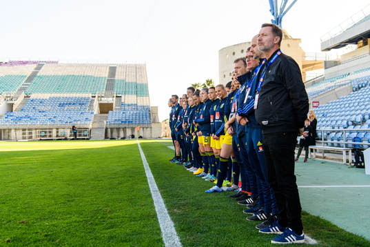 Players and staff of Sweden line up for the national anthems
