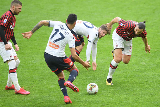 Zlatan Ibrahimovic of Milan and Cristian Romero of Genoa