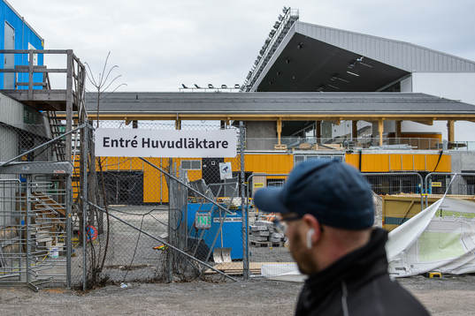 A man walks by the temporary entrance to Studenternas IP as