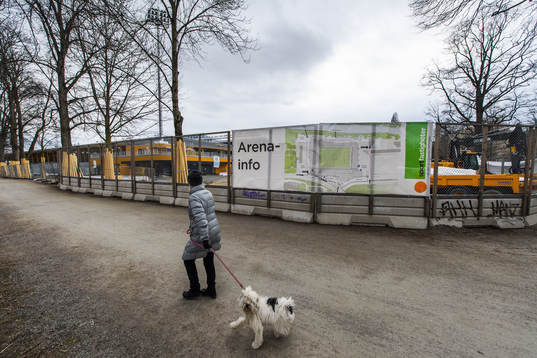 A woman with a dog walks by Studenternas IP as the