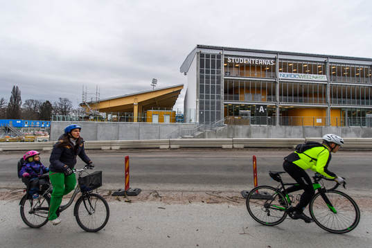 Two cyclists pass Studenternas IP as the coronavirus,