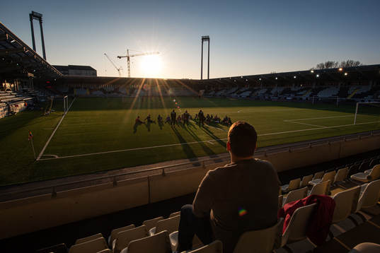 A father watches his son’s football practice at Bravida