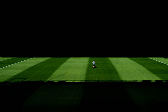 A groundsman maintains the pitch