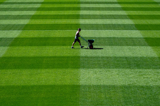 A groundsman maintains the pitch