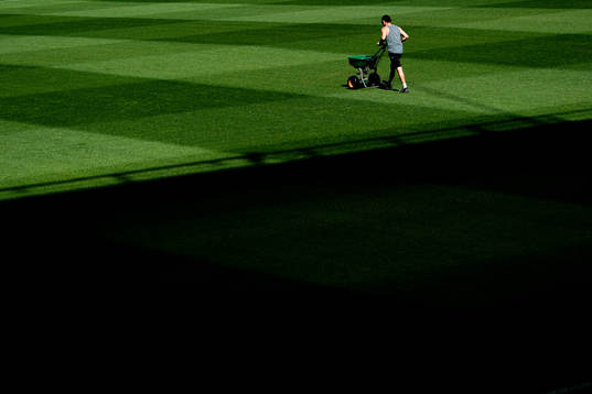A groundsman maintains the pitch