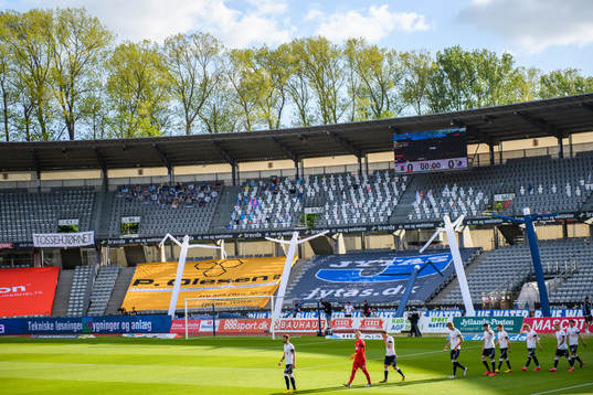 Paper dolls in the stands as players of Aarhus enter the