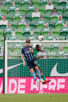 Jacob Une Larsson of Djurgården and Franck Boli of