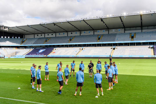 Players of Malmö FF warm up head of a practice and press