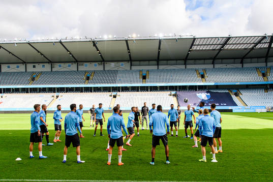 Players of Malmö FF warm up head of a practice and press