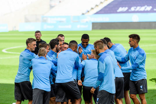 Players of Malmö FF warm up head of a practice and press