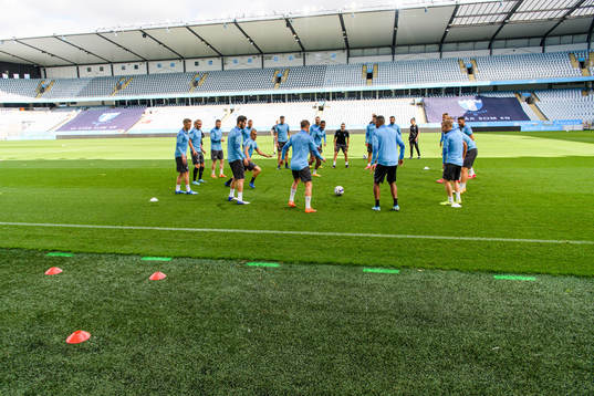 Players of Malmö FF warm up head of a practice and press