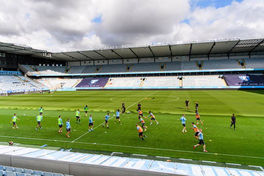 Players of Malmö FF warm up head of a practice and press