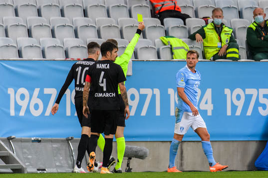 Eric Larsson of Malmö FF receives a varning from referee