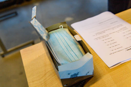 Face masks are handed out from a box