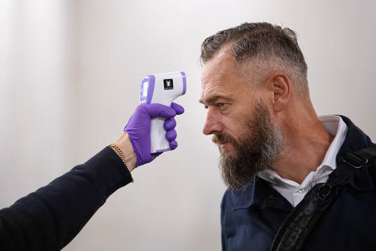 Swedish journalist Olof Lundh has his temperature checked