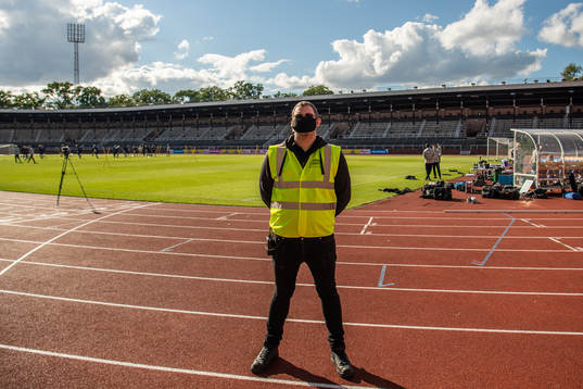 A security guard with a face mask