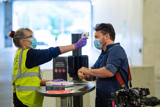 Videographer Oscar Dahl of TV4 has his temperature checked