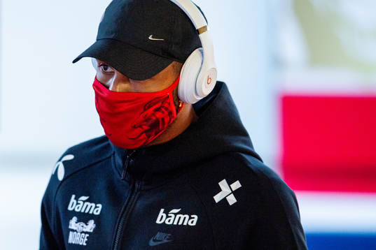 Joshua King of Norway arrives wearing a face mask