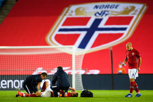 Stefan Johansen of Norway receives medical treatment