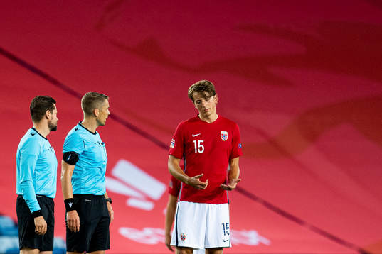 Sander Berge of Norway talks to referee Mattias Gestranius