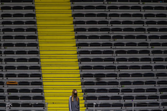 A volunteer in front of empty stands