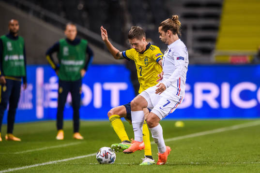 Mikael Lustig of Sweden and Antoine Griezmann of France