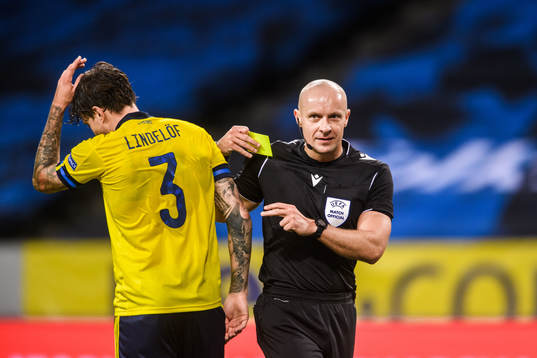 Victor Nilsson Lindelöf of Sweden receives a warning from