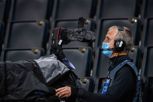 A camera man with respiratory protection due to the corona