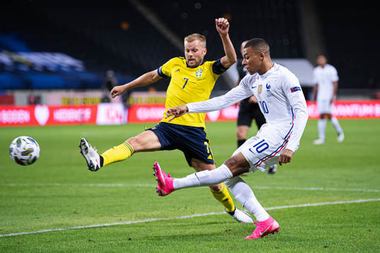 Sebastian Larsson of Sweden and Kylian Mbappé of France