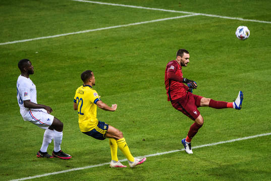 Goalkeeper Hugo Llorisof France and Robin Quaison of Sweden