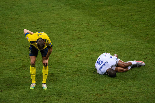Marcus Berg of Sweden and Presnel Kimpembe of France in pain