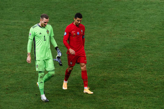Goalkeeper Robin Olsen of Sweden and Cristiano Ronaldo of