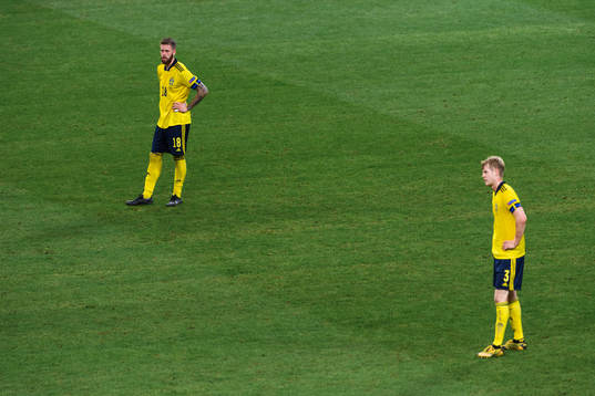Pontus Jansson and Filip Helander of Sweden look dejected