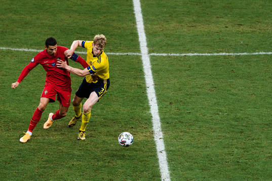 Cristiano Ronaldo of Portugal and Filip Helander of Sweden