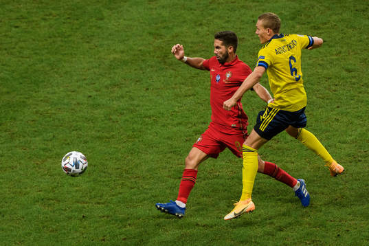 Joao Moutinho of Portugal and Ludwig Augustinsson of Sweden