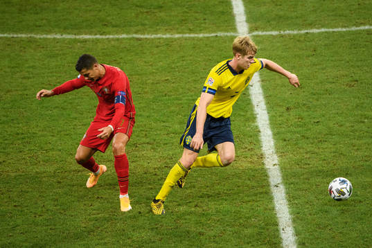 Cristiano Ronaldo of Portugal and Filip Helander of Sweden