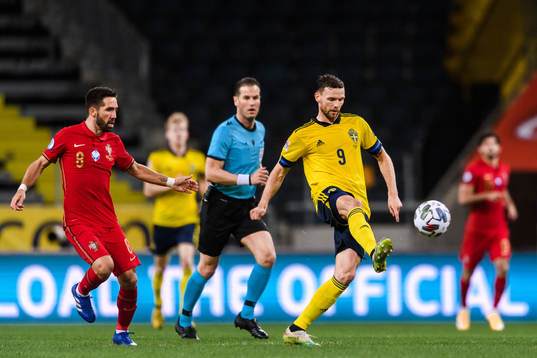 Joao Moutinho of Portugal and Marcus Berg of Sweden