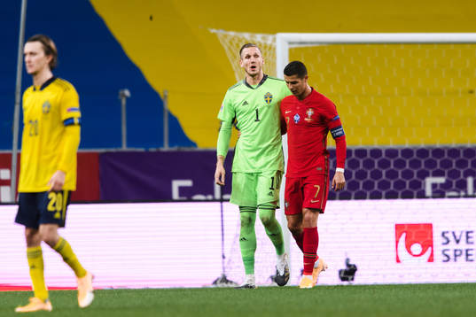 Goalkeeper Robin Olsen of Sweden and Cristiano Ronaldo of