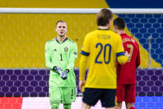 Goalkeeper Robin Olsen of Sweden and Cristiano Ronaldo of