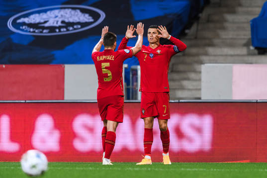 Raphael Guerreiro and Cristiano Ronaldo of Portugal