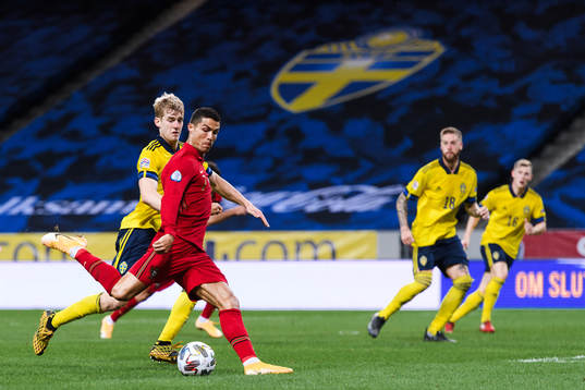 Filip Helander of Sweden and Cristiano Ronaldo of Portugal