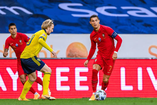 Emil Forsberg of Sweden and Cristiano Ronaldo of Portugal