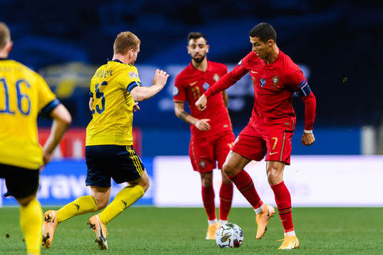 Dejan Kulusevski of Sweden and Cristiano Ronaldo of Portugal