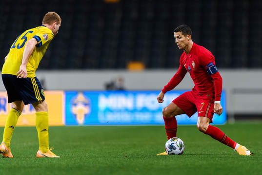 Dejan Kulusevski of Sweden and Cristiano Ronaldo of Portugal