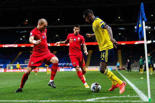 Pepe and Joao Cancelo of Portugal against Alexander Isak of