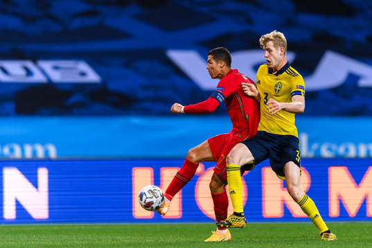 Cristiano Ronaldo of Portugal and Filip Helander of Sweden