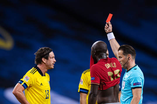 Gustav Svensson of Sweden is being awarded a red card by